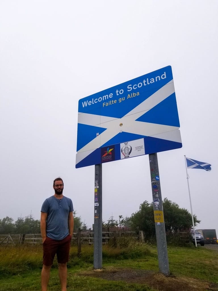 A sign of the Scottish flag that says welcome to Scotland on the Scottish English border.