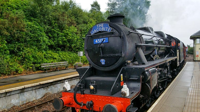 The Jacobite in Scotland is the famous Hogwarts Express from Harry Potter, the photo shows the steam train entering the station. Ride this on a trip to Scotland