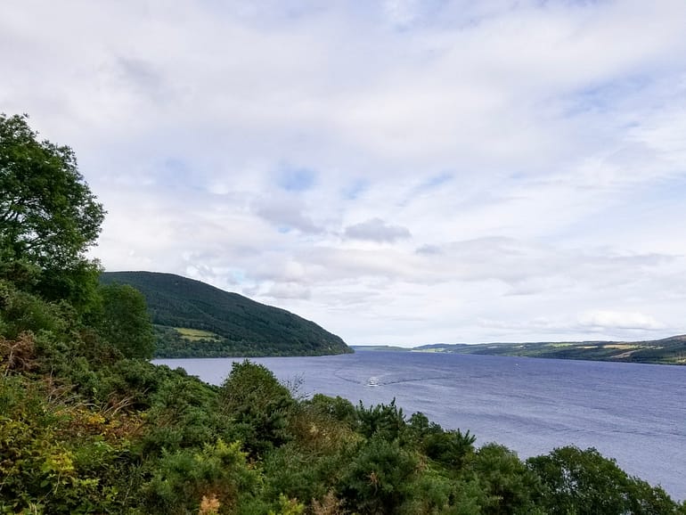 A photo of the famous Loch Ness in Scotland - a large lake with a forest in the foreground.
